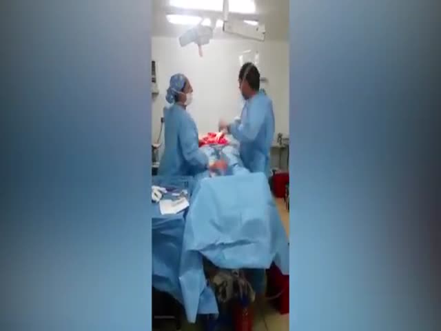 Хирург и медсестра танцуют во время операции