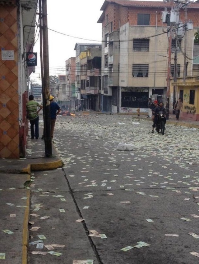 Жители Венесуэлы выбрасывают на улицу обесцененную местную валюту (4 фото)