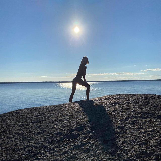 Марина Кацуба позирует на фоне солнца на камне