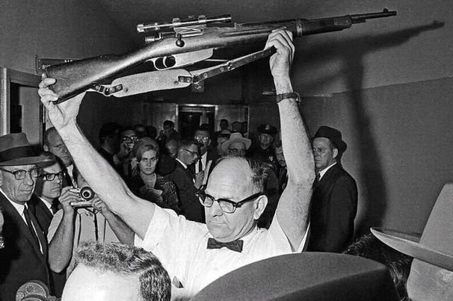 Полицейский Далласа держит карабин Каркано M91/38 калибра 6,5 мм итальянского производства , из которого, по версии следствия, был убит Джон Кеннеди. 1963 год.