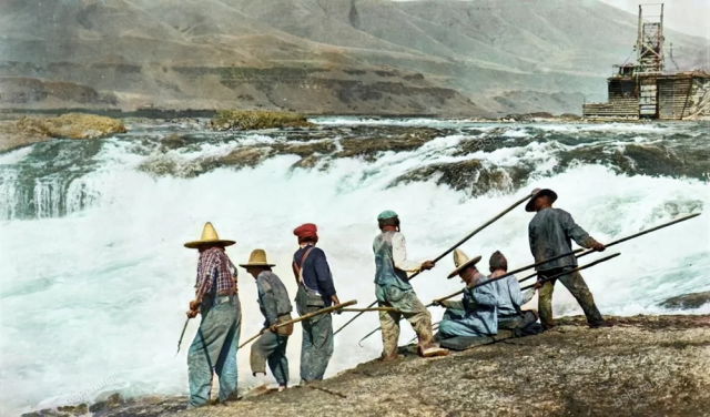 Рыбаки вооруженные копьями, ловят лосося у водопада Селило. Река Колумбия на границе штатов Орегон и Вашингтон, США, около 1920 года.