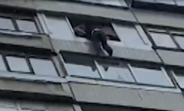 Мужчина висит на балконе в Москве