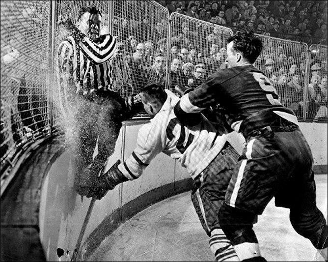 Судья Фрэнк Юдвэри пытается скрыться от столкновения с игроком, Торонто, 1956 год.